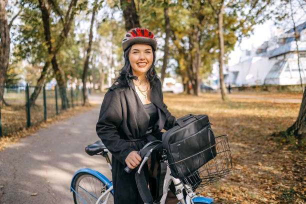 Young businesswoman Riding a bicycle on the road, Wearing a bike helmet