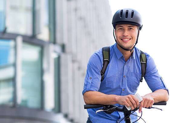 He is buckling his bike helmet.