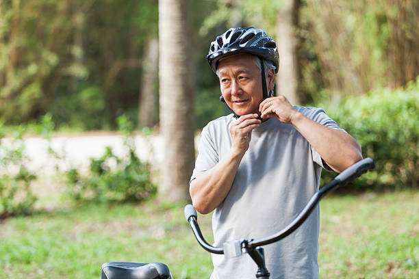 He is buckling his bike helmet.