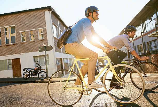 man sitting on his bike, wearing a bike helmet