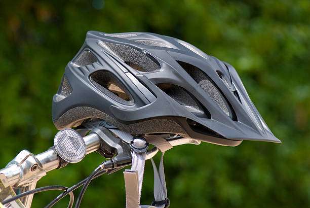 Bike helmets hanging on a coat rack by the door.
