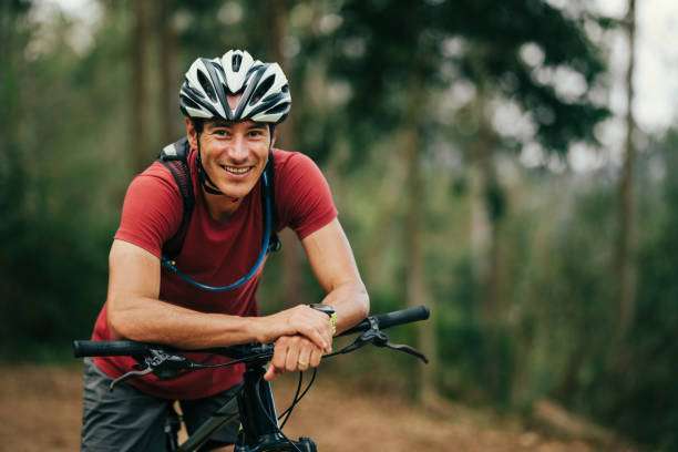 man sitting on his bike, wearing a bike helmet