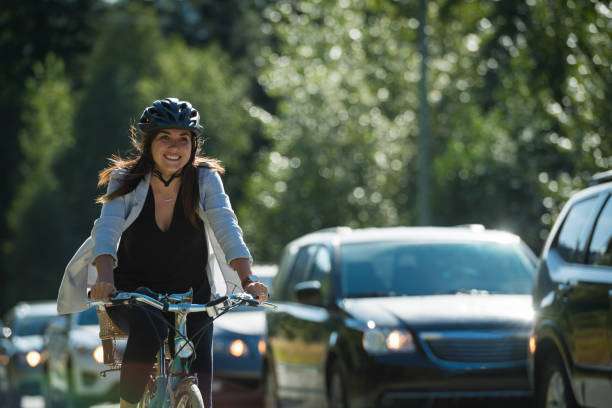 Woman passing traffic on her bike in a cycling lane bike helmet