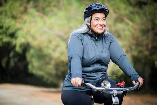 An attractive senior mexican woman biking bike helmet