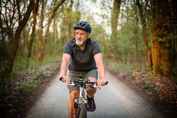 Senior man on his mountain bike outdoors bike helmet