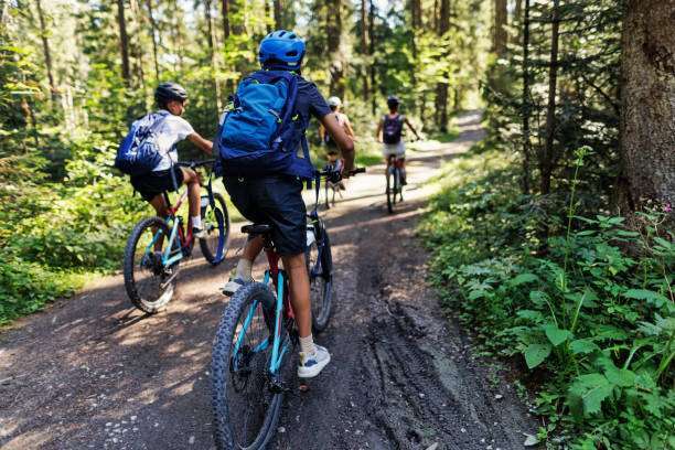 Mother and three teenage kids are enjoying a bike trip bike helmet