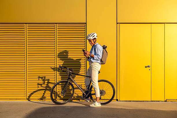 Young businessman riding, wearing a bike helmet