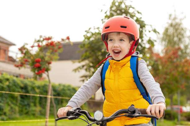 A 6-year-old boy rides his bike to school