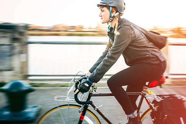 Joyful senior couple putting on bike helmets in a park
