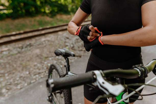 Joyful senior couple putting on bike helmets in a park
