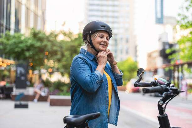 Woman adjusts her black bike helmet before riding.